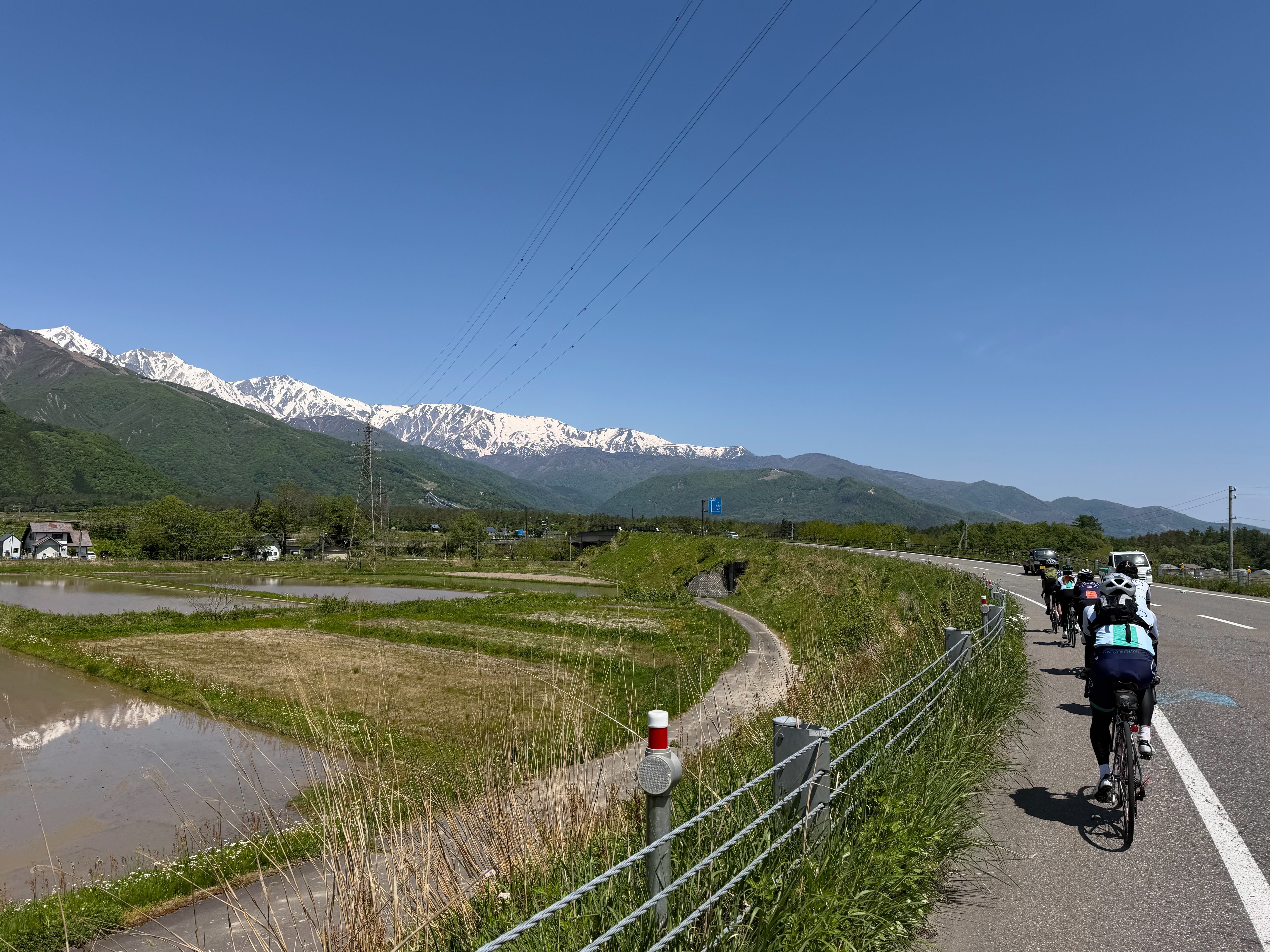 2026 North Alps — group riding with Alps panorama